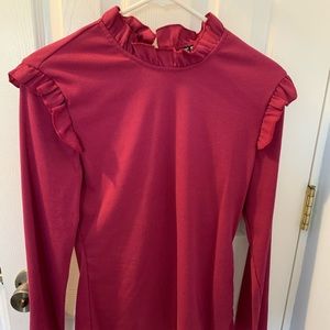 Long sleeve pinkish purple color shirt with ruffles and peep hole in the back.